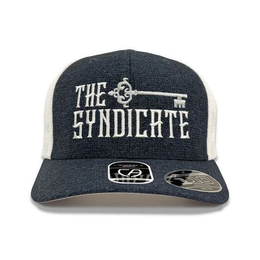 A snapback trucker hat with 'THE SYNDICATE' text and a key graphic on the front, predominantly navy with white and light gray details.